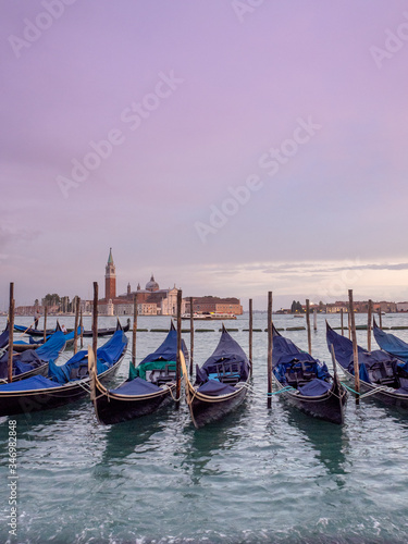 Pink sunset from San Marco square, Venice, Italy, and the gondolas in the foreground and the church of San Giorgio Maggiore