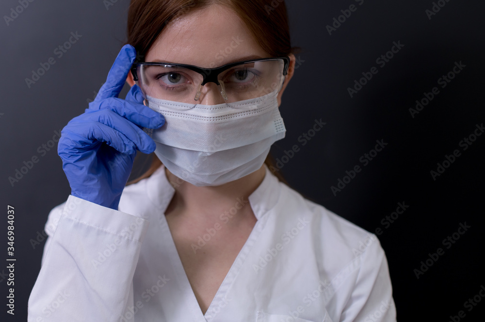 Female doctor in protective suit, medical mask, and goggles Female doctor in protective suit, medical mask, and goggles