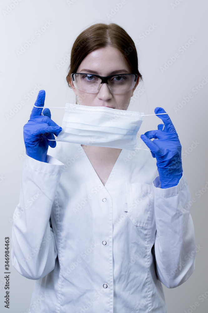 Female doctor in protective medical mask, and goggles Female doctor in protective medical mask, and goggles