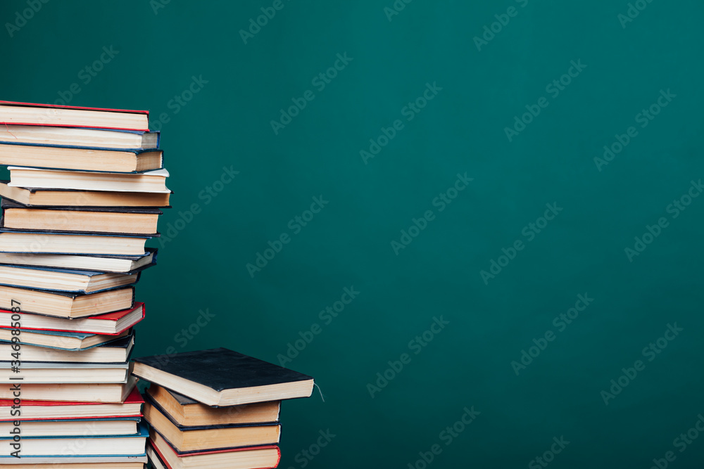 a lot of educational books for exams at the university on the green background of the library a lot of educational books for exams at the university on the green background of the library