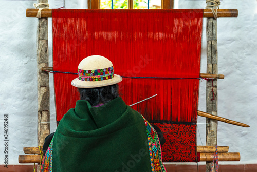 Принти на полотні A senior indigenous Bolivian Aymara woman in traditional clothing doing a demonstration of fabric or textile weaving in Sucre, Bolivia