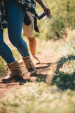 A close up of two hikers walking
