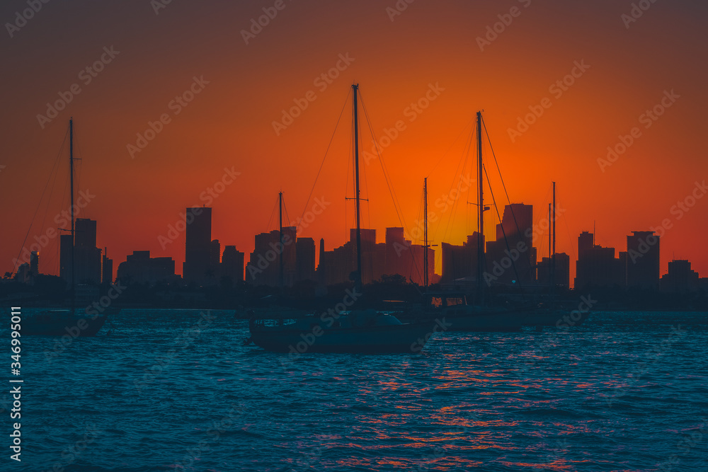 sunset water horizon miami florida sky port city buildings sea fishing boat dusk silhouette sun