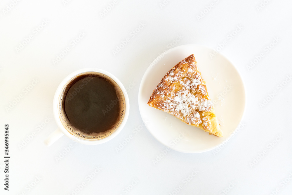 Isolated delicious apple pie (charlotte) and a cup of black coffee on white background. Bake at home apple pie dessert. Recipe of homemade pastry.