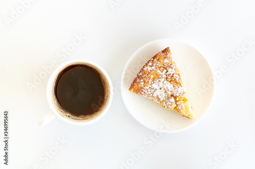 Obraz na płótnie Isolated delicious apple pie (charlotte) and a cup of black coffee on white background. Bake at home apple pie dessert. Recipe of homemade pastry. w salonie