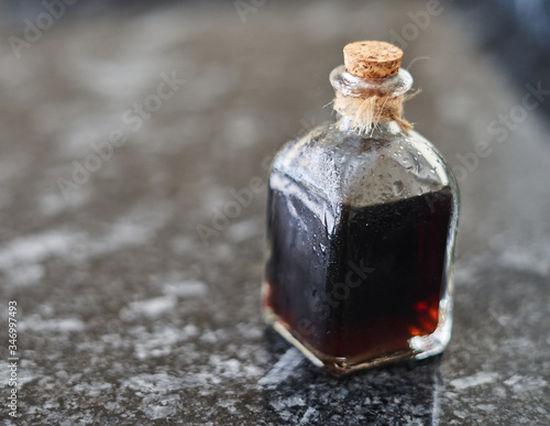 flask with coffee liquor on black stone background
