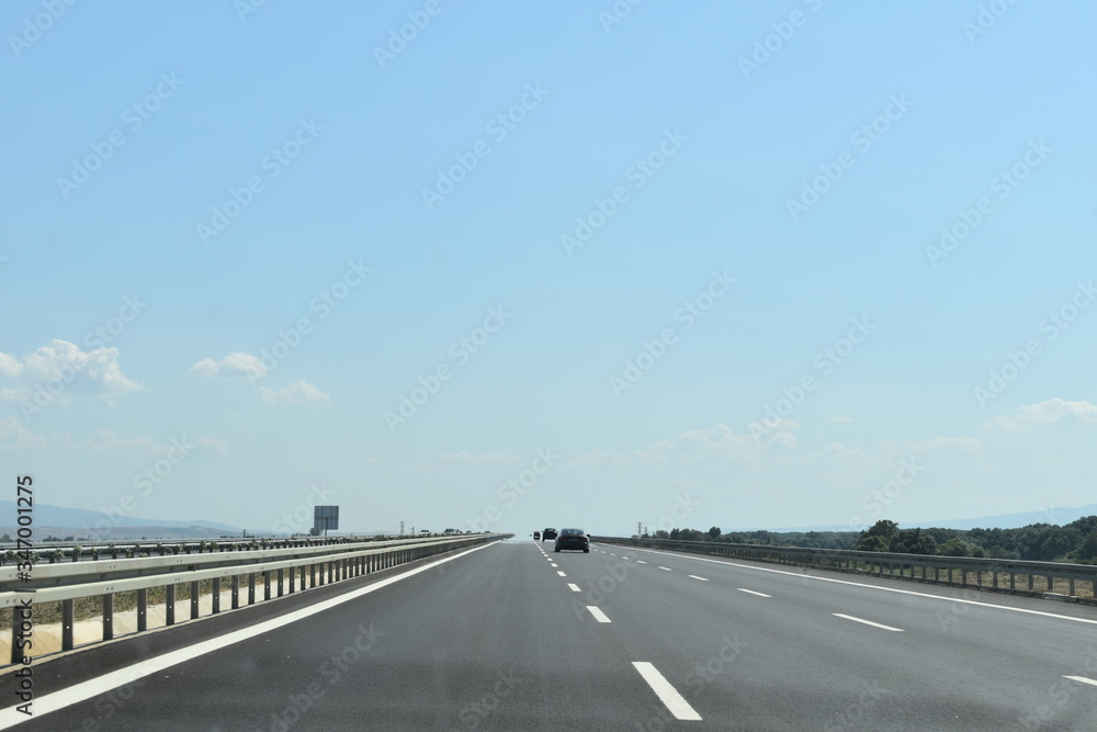 Driving on the fast lane on a long and endless straight road 