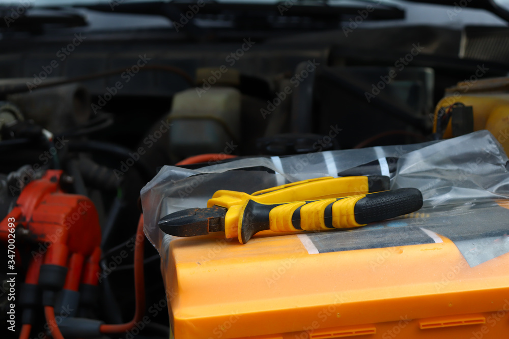 Fototapeta premium tool nippers are on the car, repair under the hood of the car, motor inspection