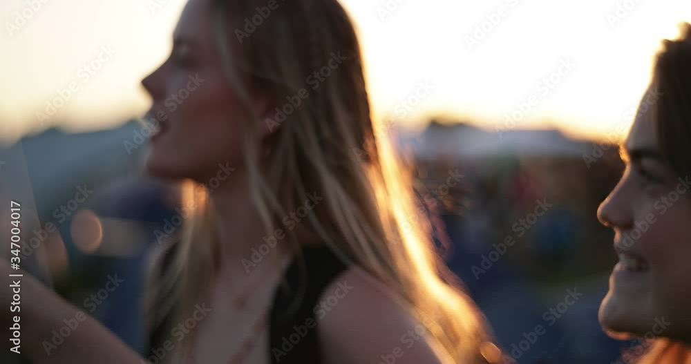 caucasian girls at festival camping site in backlight and flare walking in slow motion tracking shoot defocused caucasian girls at festival camping site in backlight and flare walking in slow motion tracking shoot defocused
