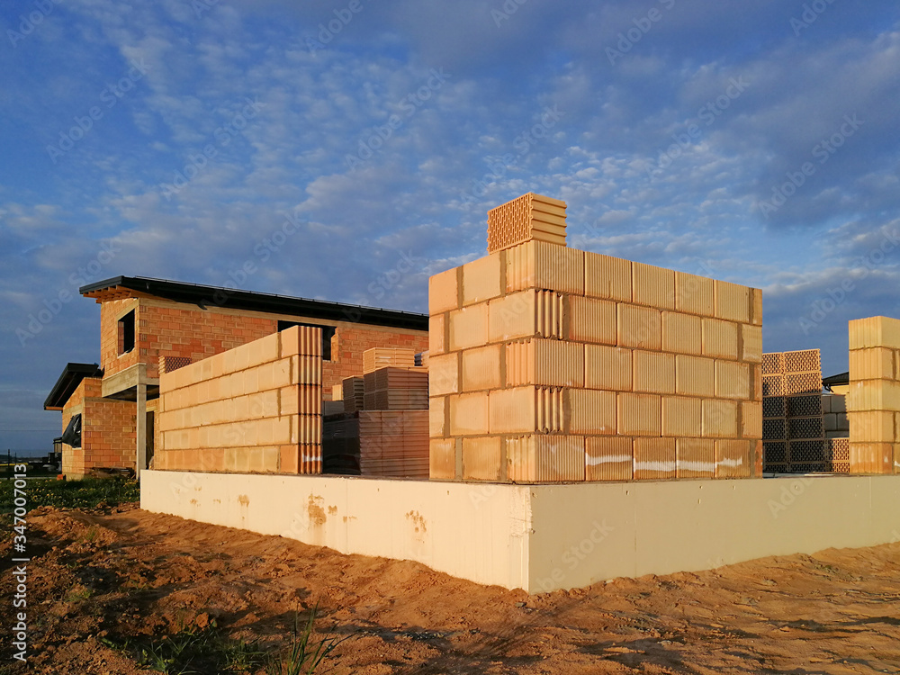 View of unfinished house constructed from ceramic blocks in construction site View of unfinished house constructed from ceramic blocks in construction site