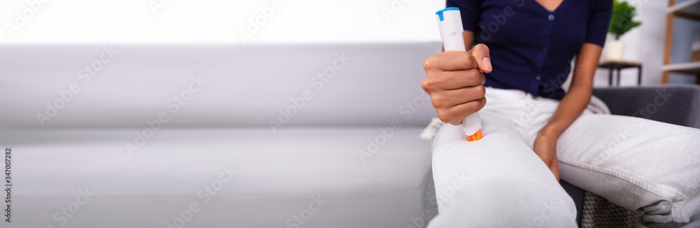Woman Injecting Epinephrine Using Auto-injector Syringe Woman Injecting Epinephrine Using Auto-injector Syringe