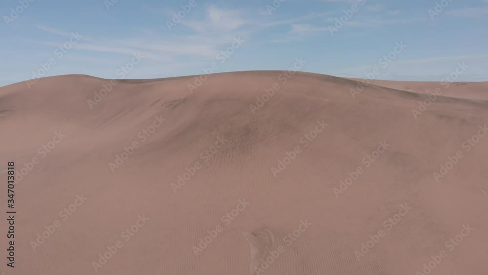 Aerial view up the dunes and behind there are more dunes and some vegetation Aerial view up the dunes and behind there are more dunes and some vegetation