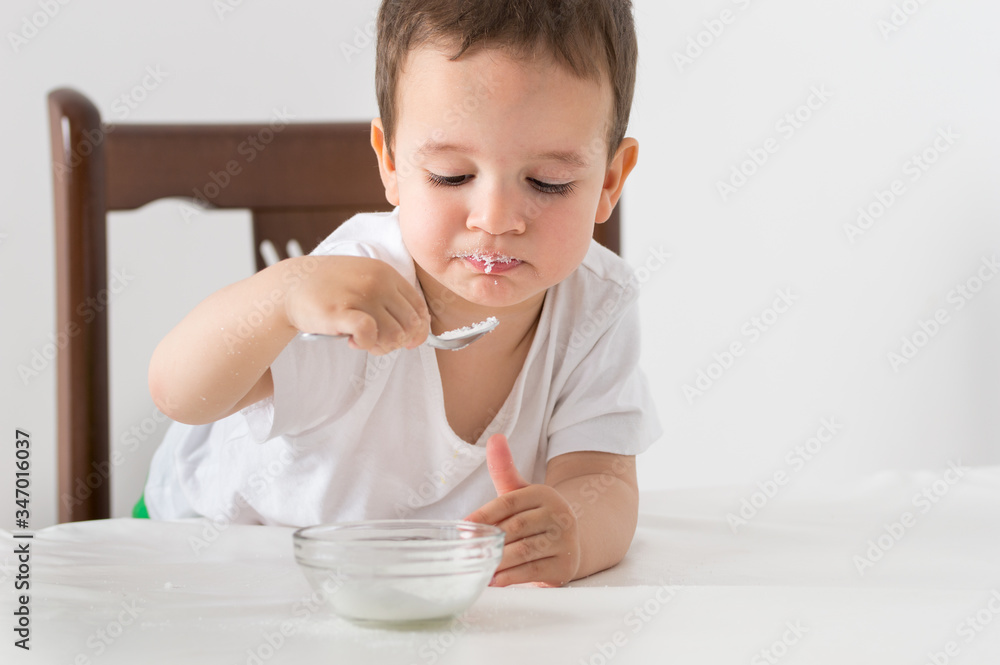 Cropped shot of a little boy eating breakfast at home Cropped shot of a little boy eating breakfast at home