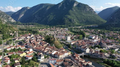 General aerial view of small French town of Tarascon-sur-Ariege in valley of Pyrenees on banks of Ariege river on summer day photo