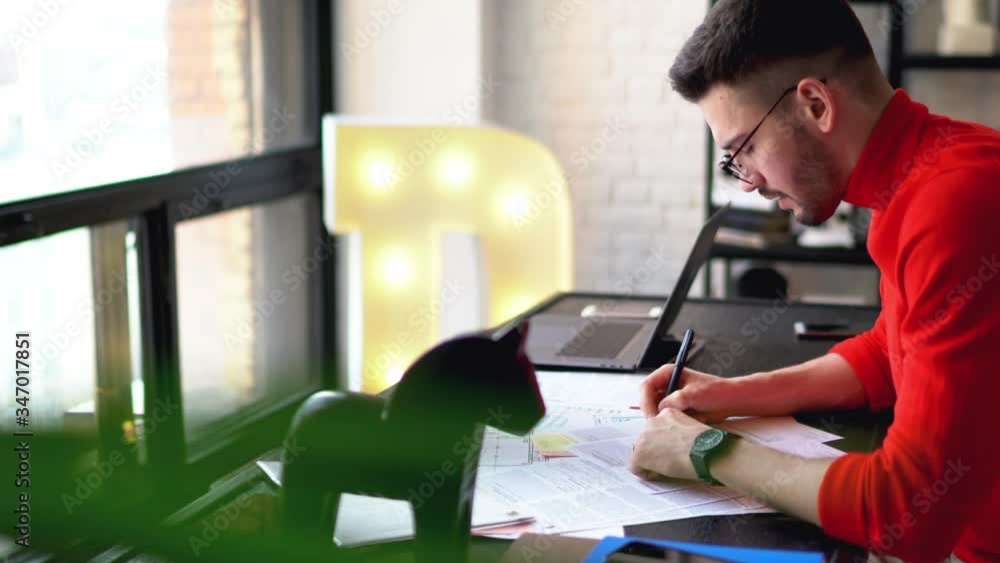 Pensive young man in casual wear writing down information on paper sitting at table in modern apartment.Skilled hipster guy doing homework and preparing for exams in free time in flat
Pensive young man in casual wear writing down information on paper sitting at table in modern apartment.Skilled hipster guy doing homework and preparing for exams in free time in flat