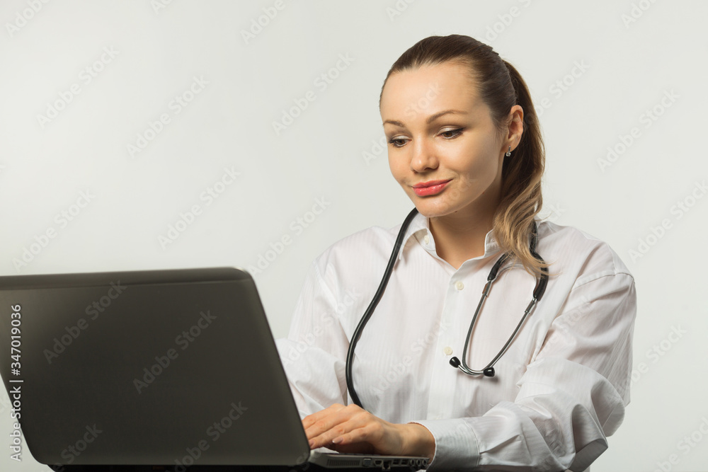 beautiful young woman at a table with a laptop beautiful young woman at a table with a laptop
