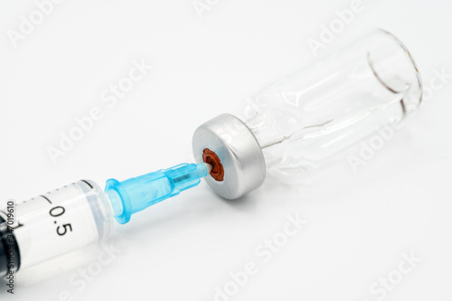 Medicine bottle for injection, medical glass vials and syringe for vaccination on white background .