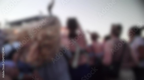 Blurred crowd of dancing girl at music festival in slow motion