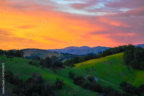 Landscape of beautiful California green hills at sunset