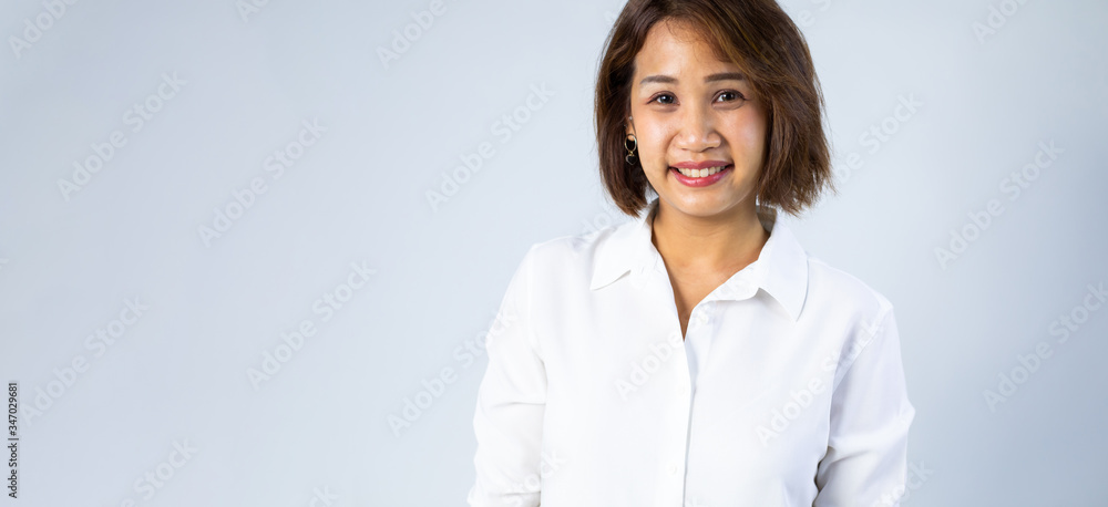 Portrait of Young Asian pretty cute cheerful business woman keeping arms crossed and smiling close up and looking at camera on white background. natural make-up, and white teeth Portrait of Young Asian pretty cute cheerful business woman keeping arms crossed and smiling close up and looking at camera on white background. natural make-up, and white teeth