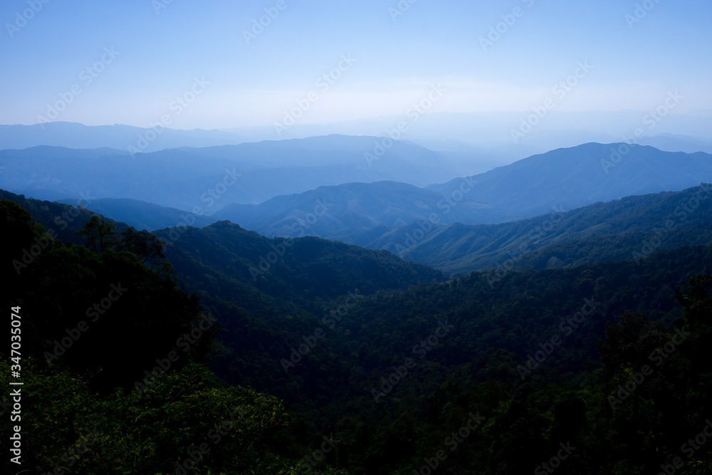 Mountain background from Thailand,Mountains, fog and morning sun in winter Mountain background from Thailand,Mountains, fog and morning sun in winter