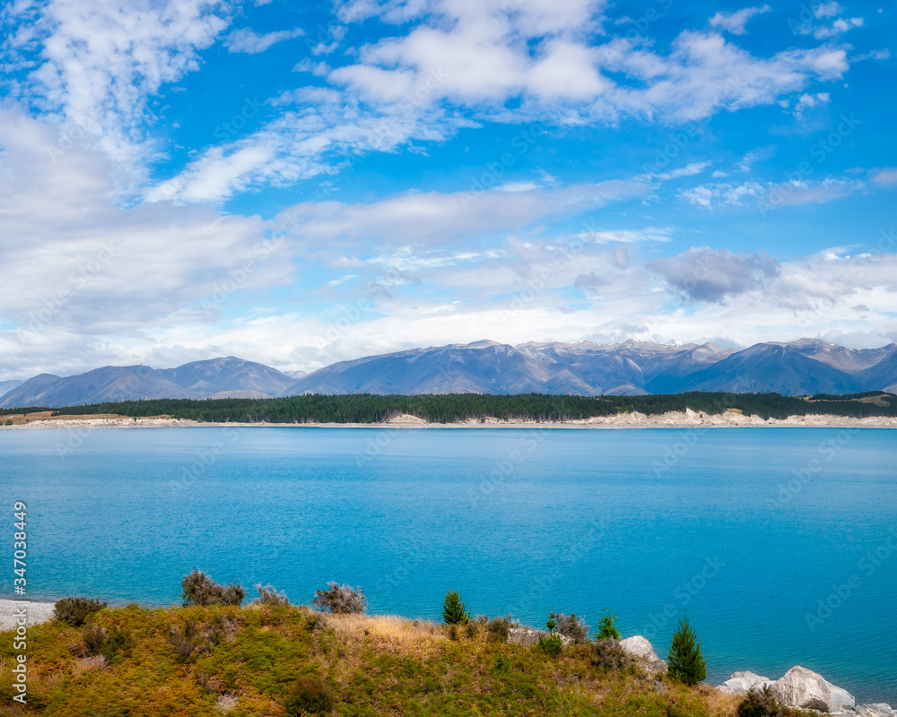 Beautiful view of Lake Pukaki, an alpine lake famous for the amazing turquoise hues of the water and the sharp mountain ranges surrounding it, in New Zealand, South Island.