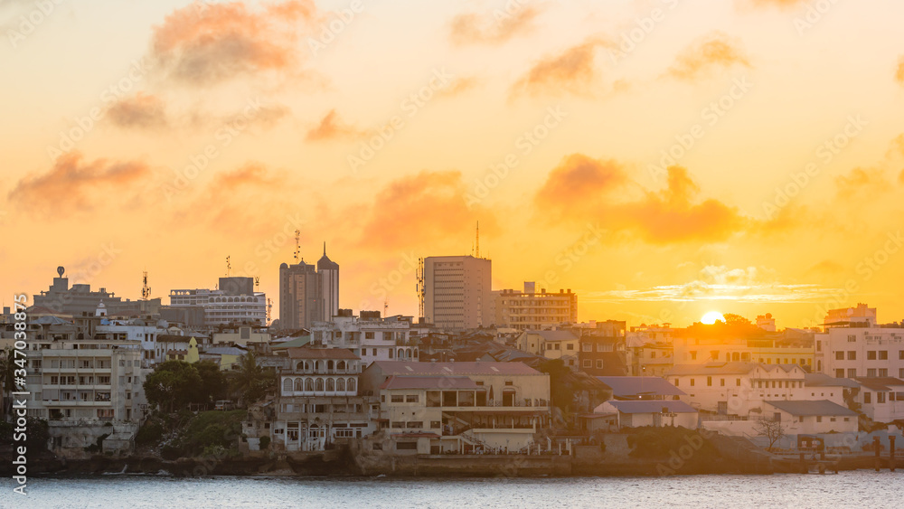 Sun set of Mombasa Island as seen from the main land, The sun rays from the sky lite up the buildings