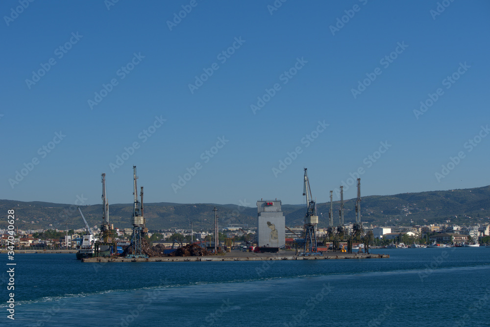 Volos ,Greece, 5/8/2020 . Mobile port cranes are loading scrap metal for recycling