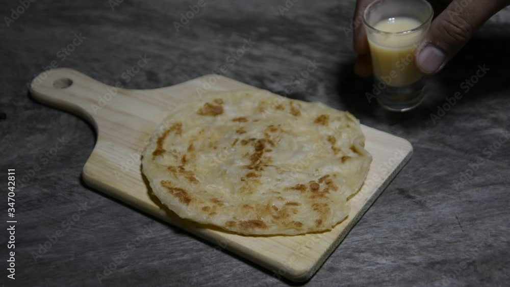Vidéo Stock Roti and sweetened condensed milk on a wooden table, roti ...
