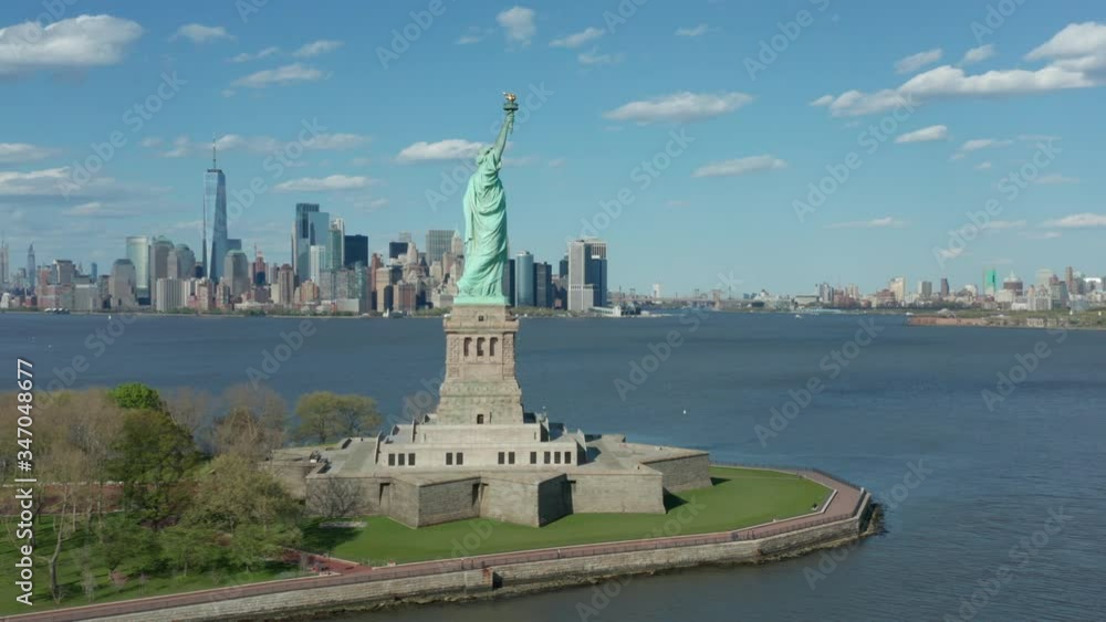 alt flying counter clock around Statue of Liberty w NYC in bkrd alt flying counter clock around Statue of Liberty w NYC in bkrd