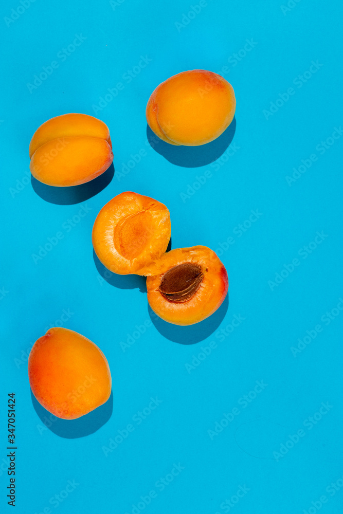 Ripe large apricot on a blue background. Ripe large apricot on a blue background.