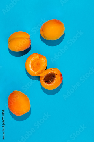 Ripe large apricot on a blue background.