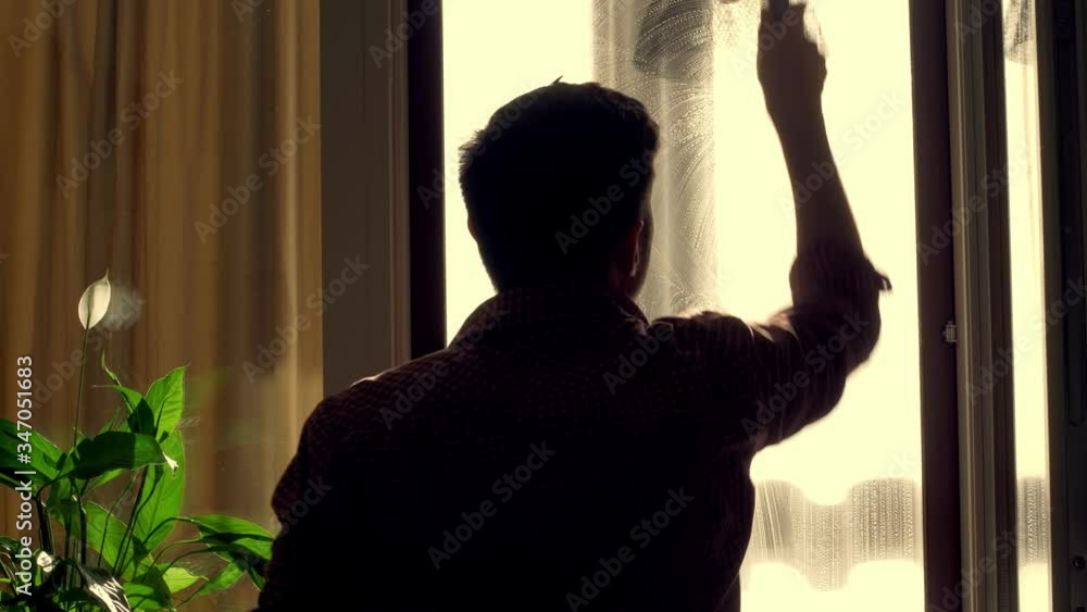 A worker washes a window at home, uses special tools A worker washes a window at home, uses special tools