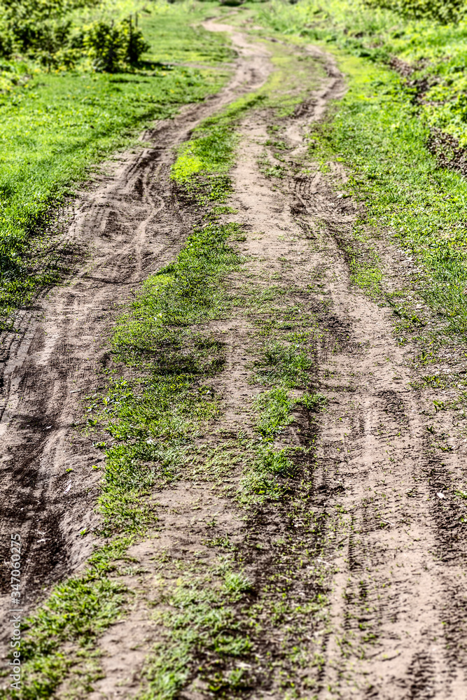Rural winding dirt track of a road closeup.