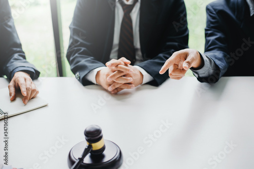 Businessmen and lawyers meeting and discuss lawsuit in the office.