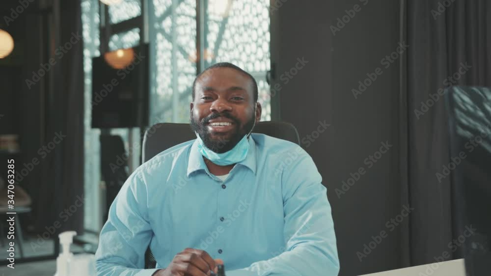 Face smiling young african american man remove mask look at camera at modern office successful worker portrait businessman coronavirus pandemic quarantine covid slow motion Face smiling young african american man remove mask look at camera at modern office successful worker portrait businessman coronavirus pandemic quarantine covid slow motion