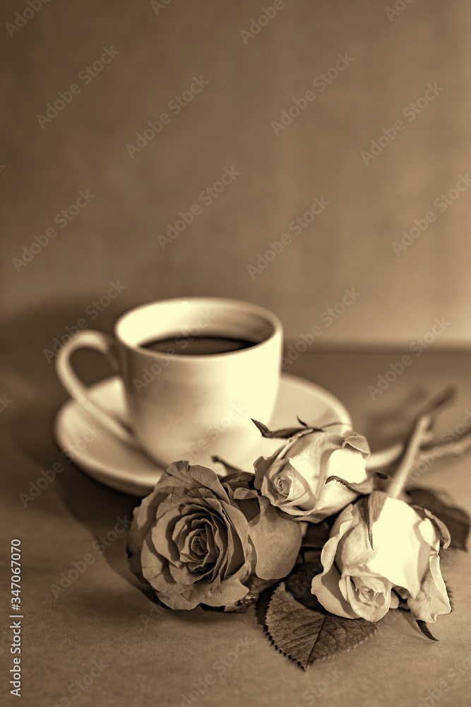 Orange yellow rose with a cup coffee in sepia color Orange yellow rose with a cup coffee in sepia color