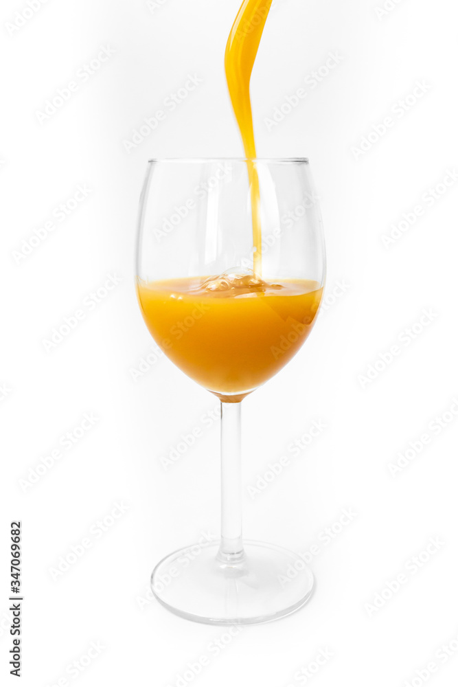 fresh orange juice is poured into a glass on a white background fresh orange juice is poured into a glass on a white background