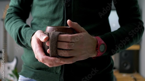 A man finishing work at a remote workplace. A freelance person who has a coffee break after work.