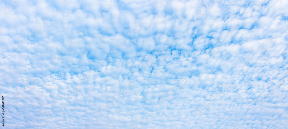 Bright Altocumulus clouds in blue sky