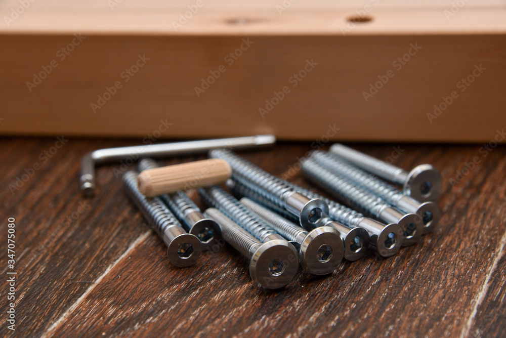 tools, screws and wooden parts for self-assembly of furniture