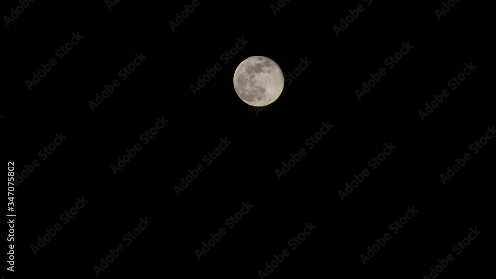 shining very big full moon in the dark black midnight sky shining very big full moon in the dark black midnight sky