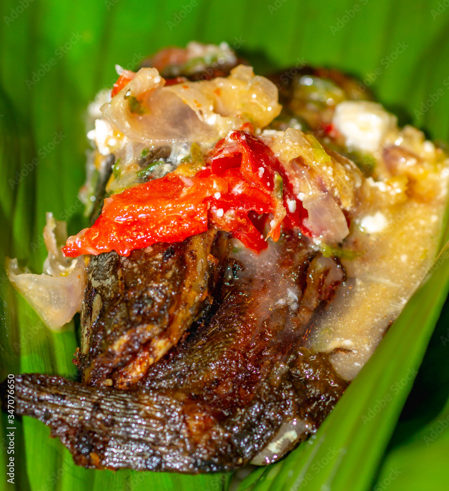 Botok lele, fried catfish served with spicy curry and wrapped with ...