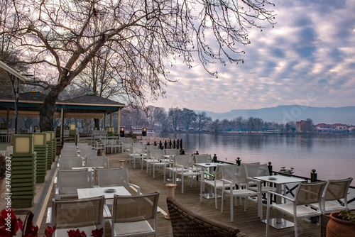 Restaurant with View to the lake Pamvotis at Ioannina city at sunset.Greece