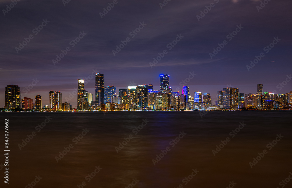 Fototapeta premium Miami, Florida, USA skyline. View from on Biscayne Bay. Night in the beautiful city of Miami. Skyscrapers in Miami Downtown. Tropical night near the ocean in Florida. City Lights.