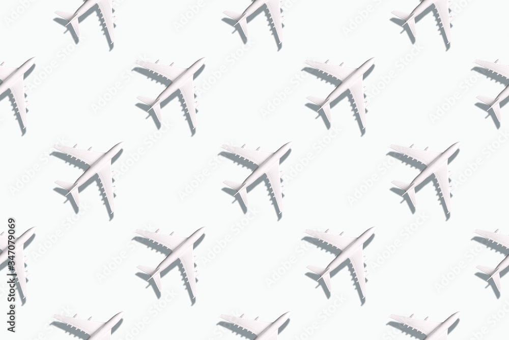 Summer pattern. Creative banner of planes on white background. Travel, vacation concept. Travel, vacation ban. Flights cancelled and resumed again. Top view. Flat lay. Minimal style design.