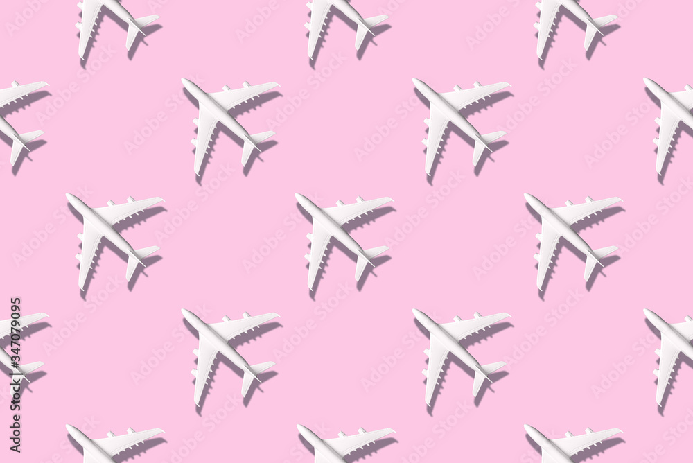 Summer pattern. Creative banner of white planes on pink background. Travel, vacation concept. Travel, vacation ban. Flights cancelled and resumed again. Top view. Flat lay. Minimal style design.