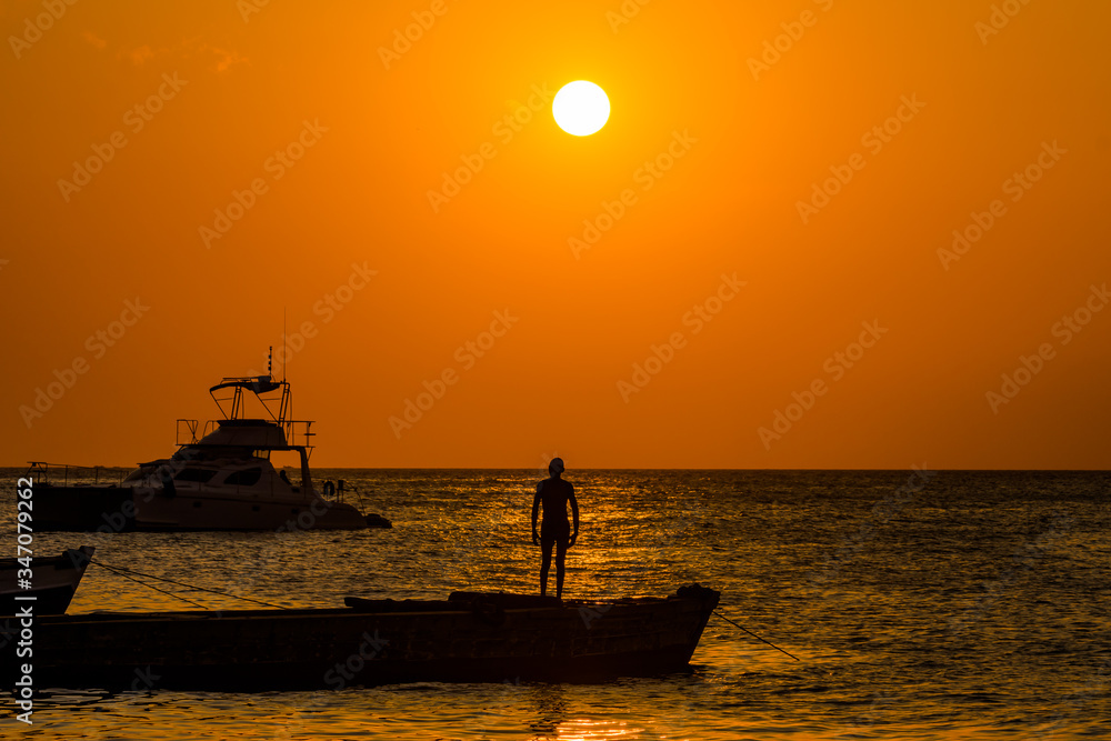 This was taken in the islands of Zanzibar at sun set. The sun was setting on the mainland side of Tanzania