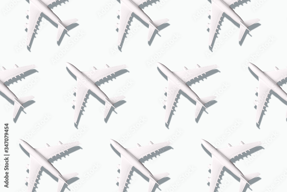 Summer pattern. Creative banner of planes on white background. Travel, vacation concept. Travel, vacation ban. Flights cancelled and resumed again. Top view. Flat lay. Minimal style design. Summer pattern. Creative banner of planes on white background. Travel, vacation concept. Travel, vacation ban. Flights cancelled and resumed again. Top view. Flat lay. Minimal style design.