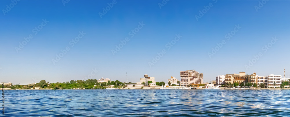 Panorama view on hotels under construction on the banks of the Nile river. Construction sites of new buildings for touristic business in Cairo, Egypt.